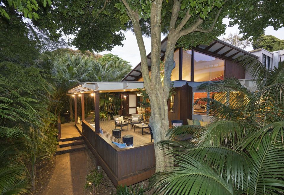 a tropical house with a large tree in the backyard , creating a serene and natural environment at Arajilla Retreat