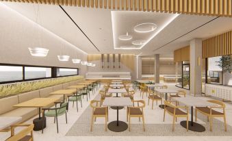 a modern , minimalist dining room with white walls and wooden ceiling , featuring multiple tables and chairs arranged around them at Myrion Beach Resort & Spa - Adults Only