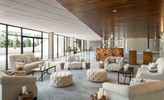 a large , modern living room with several couches and chairs arranged around a coffee table at Hilton Los Angeles-Culver City, CA