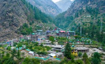 a mountainous town with traditional houses and colorful buildings is nestled in a valley surrounded by greenery at Hotel Royal Palace
