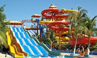 a large water park with multiple slides and a pool , filled with people enjoying themselves in the water at Orion Hotel