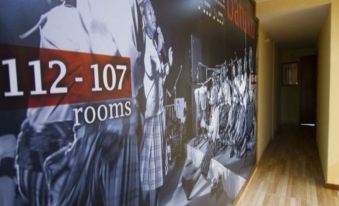 "a hallway with a long banner hanging on the wall that reads "" 1 2 - 1 0 7 rooms .""." at Hotel Santa Maria