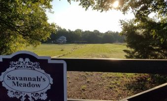 a sign for the somers meadow beer house is in front of a scenic view at Savannah's Meadow