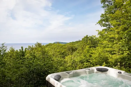Watch the Snow Fall over Lake Michigan from a Hot Tub at Our Cabin in the Woods!
