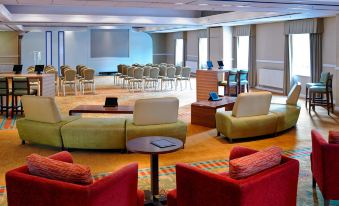 a large room with multiple couches and chairs arranged in a sitting area , creating a comfortable and inviting atmosphere for meetings and socializing at Delta Hotels Tudor Park Country Club