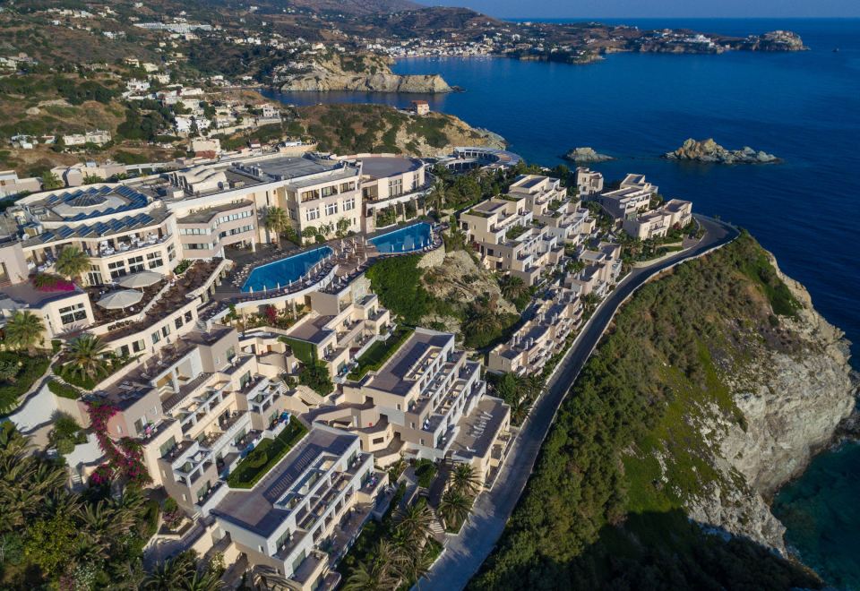 a bird 's eye view of a resort with large buildings and a body of water at Athina Palace Resort & Spa