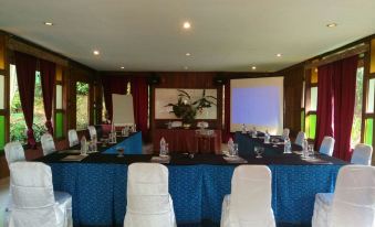 a conference room set up for a meeting , with chairs arranged in rows and a table in the center at Imah Seniman