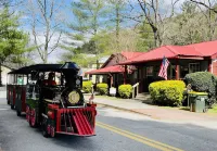 Downtown by Chattahoochee River, sit on front porch as horse and buggy stroll by
