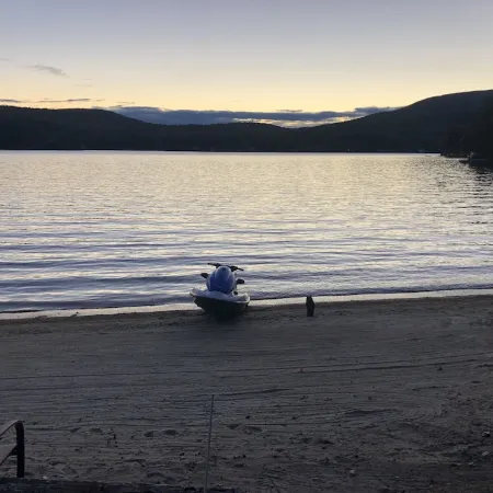 A quiet cove, the sunset and a sandy beach, on Lake Winnipesaukee