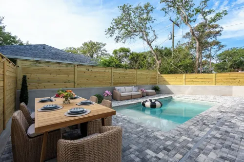 BRAND NEW 4-bedroom, 2 primary suites, heated pool, steps to the beach and river