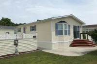 Sunny coastal home with private patio, on-site pool, central AC, & W/D