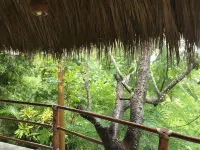 Romantic bungalow surrounded by trees.