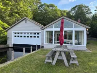 Stunning lakefront home with a boathouse, private dock, firepit and lake views
