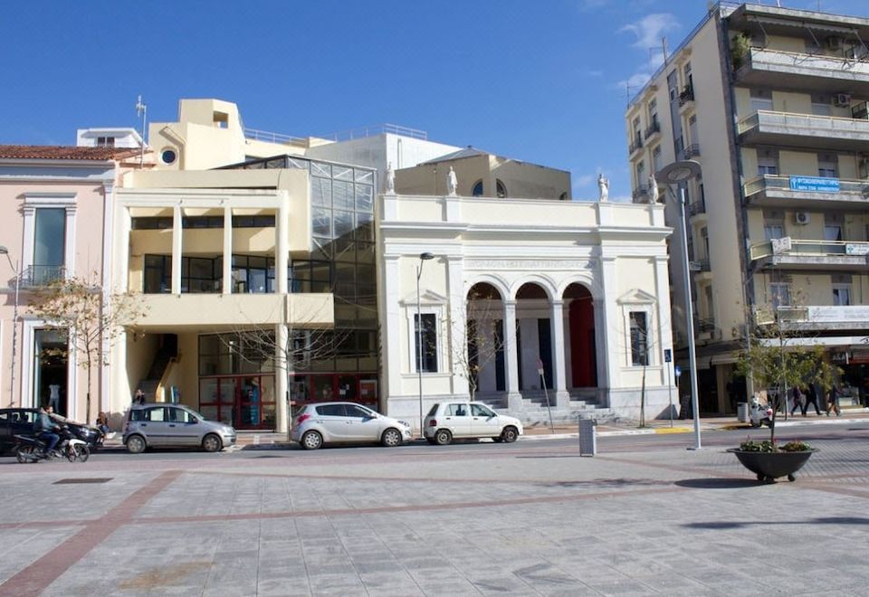 a city street with two cars parked in front of a building , one on the left and one on the right at Country Home