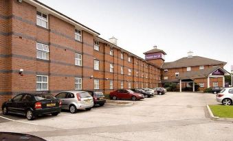 "a row of cars parked in front of a brick building with a sign that says "" malton ""." at Premier Inn Derby East