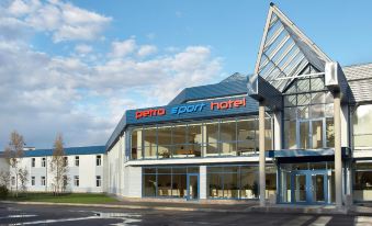 "a large hotel with a glass facade and the words "" rental sport hotel "" on it" at Petro Sport Hotel