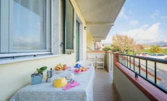 a balcony with a dining table and chairs , as well as a fruit basket on the table at Anna