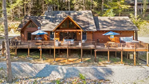 Waterfront Cabin with Hot Tub and Outdoor Fun - Cozy River Retreat