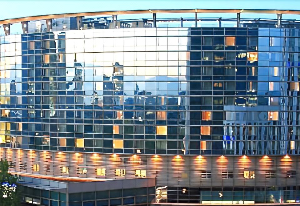 a modern building with a large glass facade and multiple lights on the ceiling , reflecting the surrounding cityscape at Hotel Zur Post Limburg Bad Camberg
