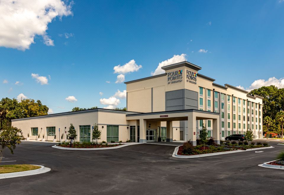 "a large , white building with the name "" american century "" on it , surrounded by a parking lot" at Four Points by Sheraton Brunswick