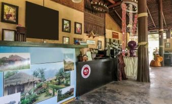 a reception area with a large screen , framed pictures on the wall , and a desk at Aurora Resort Chiangdao