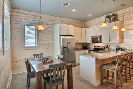 In-town coastal getaway, with a heated pool & level 2 Tesla EV charger on site.