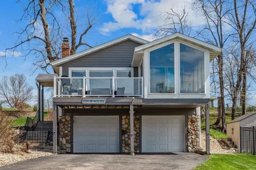 Cozy, year-round lake home with magnificent sunset views, lake access and dock.