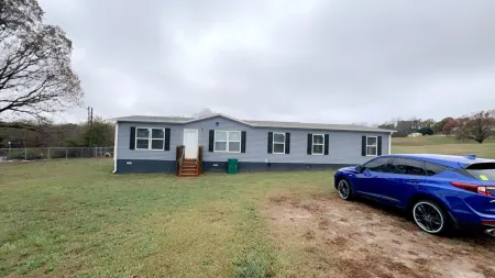 4-bedroom home on 5.75 acres. Home is located near Chimney Oaks Golf Course.