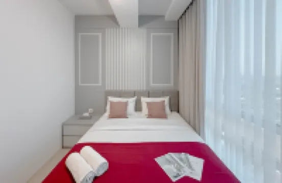 Combined Grey Toned 2BR Apartment at The City Square Surabaya By Travelio