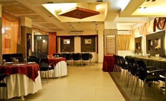 a large dining room with tables and chairs arranged for a group of people to enjoy a meal together at Hotel Majestic Shillong