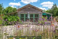 The Garden Room. Timber framed, light and airy accommodation with veranda.