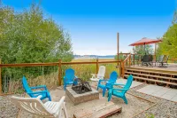 Single-level, lakefront getaway with mini-bar, furnished deck & mountain views