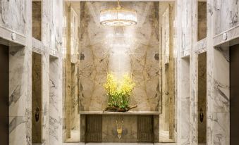 A spacious room features an elaborate ceiling and marble countertops, located next to the door at The Royal Pacific Hotel and Towers