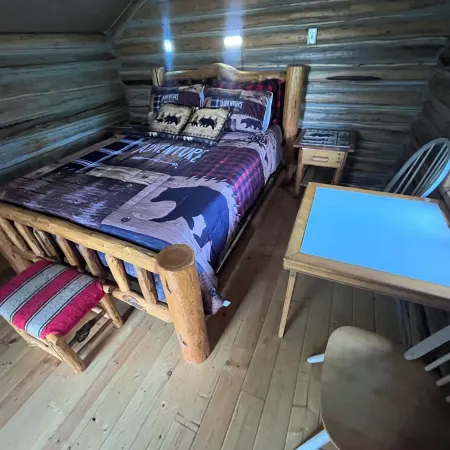 Retreat to our cozy cabin nestled in a private hideaway.Solar lights & shower