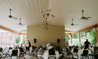 a large dining room with tables and chairs set up for a formal event , possibly a wedding reception at Bicentennial Inn