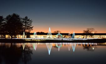 a serene nighttime scene of a large body of water , possibly a lake or a river , with a dock in the foreground at Karuizawa Prince Hotel East