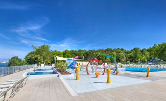 a sunny day at a water park with multiple slides and play structures for children to enjoy at Lanterna Premium Camping Resort by Valamar