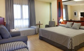 a hotel room with three beds , two of which are twin beds and one is a double bed at Hotel Olympia Valencia