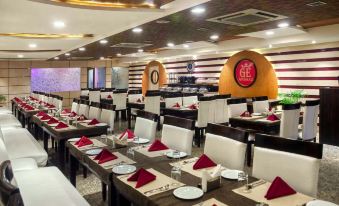 a large dining room with multiple tables and chairs , some of which are set for a meal at Emporio Hotel