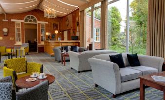 a cozy living room with two couches , one on the left and one on the right side of the room at Best Western Moore Place Hotel