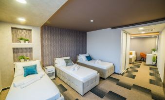 a hotel room with three beds , two of which are twin beds and one is a double bed at Hotel River