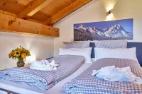 Cozy 65 sqm attic apartment with open roof truss and two balconies