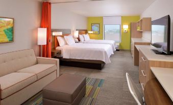 a hotel room with two beds , one on the left and one on the right side of the room at Home2 Suites by Hilton Merrillville