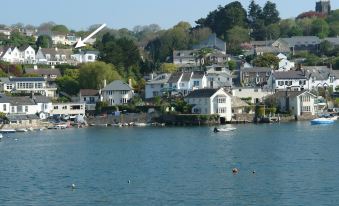 a large body of water with boats docked on it , surrounded by houses and hills at The Porthole