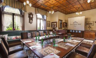 a conference room set up for a meeting , with tables and chairs arranged in a semicircle at Green Garden Hotel