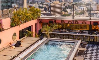 There is a swimming pool with a view of the city in the background, as well as an elevated rooftop bar on the top floor that overlooks the city at Brown BoBo, a Member of Brown Hotels
