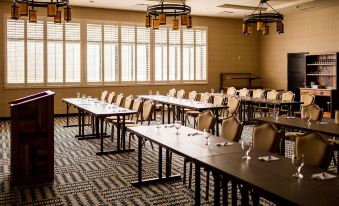 a large conference room with multiple long tables and chairs arranged for a meeting or event at Tailwater Lodge Altmar, Tapestry Collection by Hilton