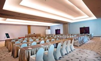 a large conference room with rows of chairs arranged in a semicircle , ready for a meeting or event at Grand Artos Hotel & Convention