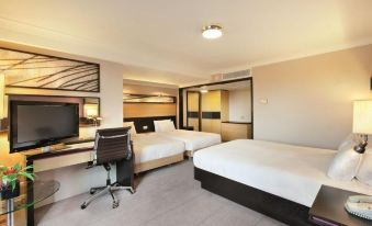 a modern hotel room with two beds , a desk , and a tv , all neatly arranged at DoubleTree by Hilton Manchester Airport