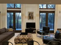 Stunning and private mid-century modern inspired cottage nestled in the woods.